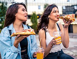 young adults eating pizza